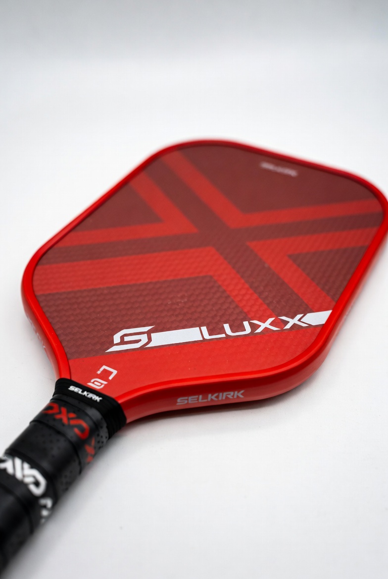 Selkirk LUXX Control Air pickleball paddle in red colorway on white background showing paddle face and handle